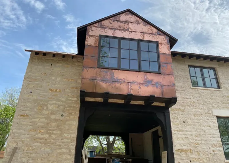 Copper metal panel facade on a stone building for Skylight Installation in Fayetteville